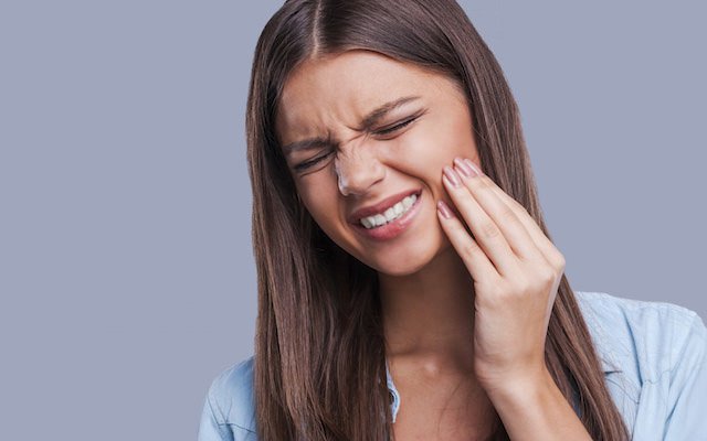 woman having tooth pain